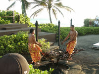 Pulling the pig out of the fire pit at Germaine's Luau
