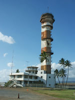 Original Ford Island control Tower.
The shorter building is the Control Tower.
The tall structure is not a control tower. It was filled with water and used to train Naval deep sea divers